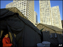 A woman living in a tent near skyscrapers in Beijing, China (2007)