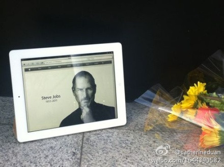 一位苹果员工从总部一号楼出来，在纪念的地方放下一个白色iPad，这应该是乔布斯最喜欢的相框。