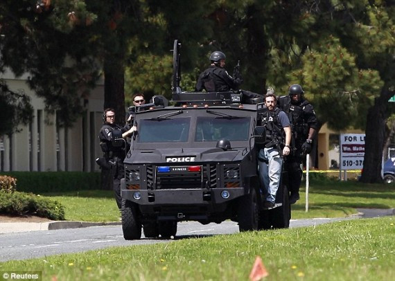 Police arrive in an armoured vehicle after a gunman opened fire killing seven at Oikos University yesterday