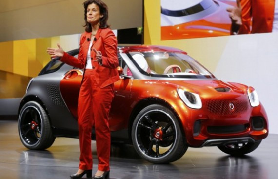 Head of Smart brand Annette Winkler gives a speech next to a Smart ForStars model on media day at the Paris Mondial de l'Automobile