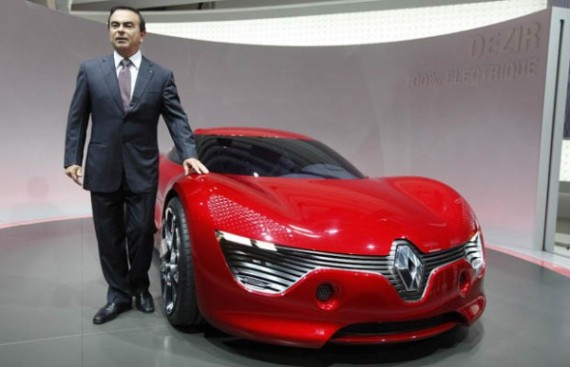 Carlos Ghosn, Chairman and Chief Executive Officer of French carmaker Renault, poses next to the Dezir concept electric car on media day at the Paris Mondial de l'Automobile