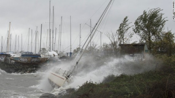 A sailboat smashes on the rocks after breaking free from its mooring on City Island, New York, on Monday. Hurricane Sandy's winds picked up speed as the storm made a left turn toward the East Coast. 