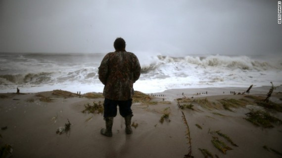 Andy Becica watches the heavy surf from Hurricane Sandy wash in Monday at Cape May, New Jersey. The full force of Hurricane Sandy is expected to hit the New Jersey coastline later Monday.