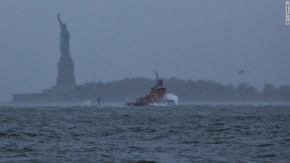  A wave crashes over the bow of a tugboat in New York Harbor on Monday.