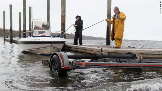 Sean Doyle of Levittown and Andrew Hodgson of Hicksville pull their boat from Long Island Sound on Sunday at Oyster Bay, New York.