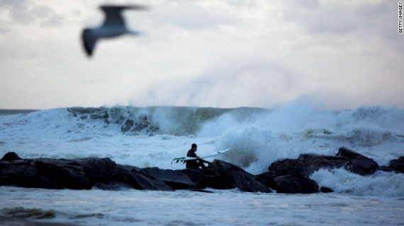 A man surfs at Rockaway Beach in Queens as Hurricane Sandy approaches Sunday.