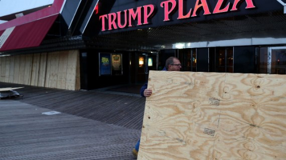 Scott Davenport brings plywood to cover the windows at the Trump Plaza casino on the boardwalk in Atlantic City, New Jersey, on Sunday. 