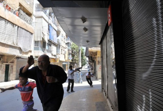 Syrian civilians take cover as fighters
