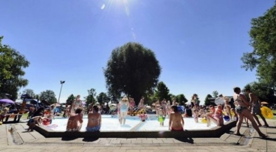Children-and-adults-enjoy-the-sun-at-an-outdoor-pool-in-the-recreation-resort-Binnenmaas-in-Mijnsheerenland-the-Netherlands-on-July-24.-AFP