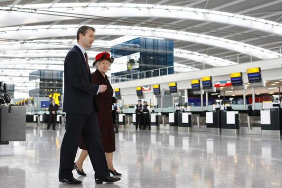 Britain's Queen Elizabeth walks with British Airports Authority  CEO Nelson inside Terminal 5, during her official opening of the new terminal at Heathrow airport, in London