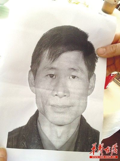 当地公安机关将嫌凶谭丙坤的照片发放到附近村民及商户手中。记者 徐德荣 摄