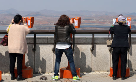 South Korean tourists look towards the North
