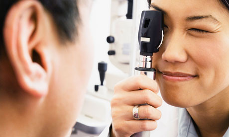 Student optometrist examining patient