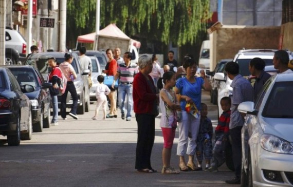 People stand outside their homes after an earthquake hit Dingxi, Gansu province