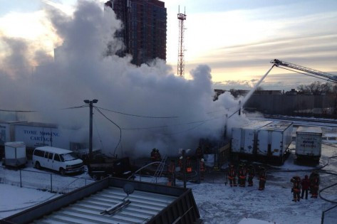 Firefighters battle a fire at a roofing storage facility on Jan. 1, 2014. CITYNEWS/Jeff Ducharme (@city18jeff).