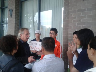 一批家長和學生們在教聯辦公室外與艾克對話,希望教聯停止罷工。(圖:姚女士提供)