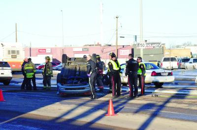 City police, fire department and paramedics respond to a vehicle rollover on southbound Allowance Avenue Friday at 3 p.m. No major injuries were reported.--NEWS PHOTO ALEX McCUAIG