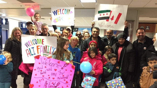 The Ali family and a welcoming party at Halifax Stanfield Airport. This week the federal government will likely hit the target of 25,000 refugees, but because one third of those are privately sponsored, another 8,000 government-sponsored refugees will be coming to Canada from Syria by year's end. 