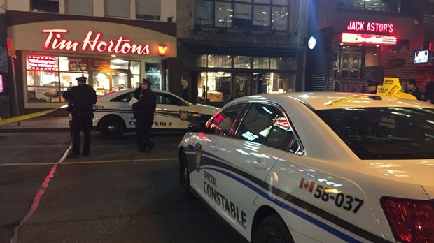 Police officers are seen outside a Tim Hortons on Yonge Street following a shooting that left one man dead on Wednesday, April 13, 2016. (CP24/Jackie Crandles) 