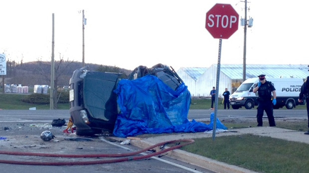 Police stand outside an SUV that was involved in a fatal collision on Dundas Street on April 16. (Christina Tenaglia/CP24)