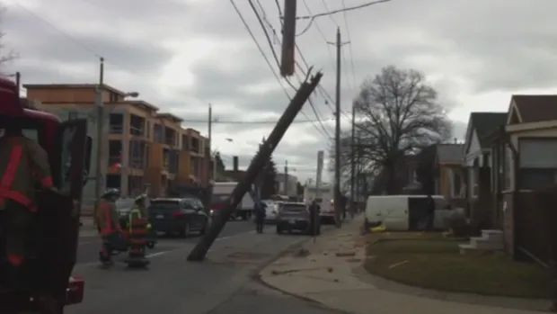 Hydro pole snapped in two by TTC bus at Jane Street, north of Bloor Street.