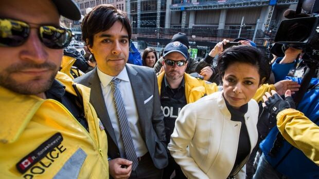 Former radio host Jian Ghomeshi, left, enters the court house with his lawyer Marie Henein on May 11, 2016.