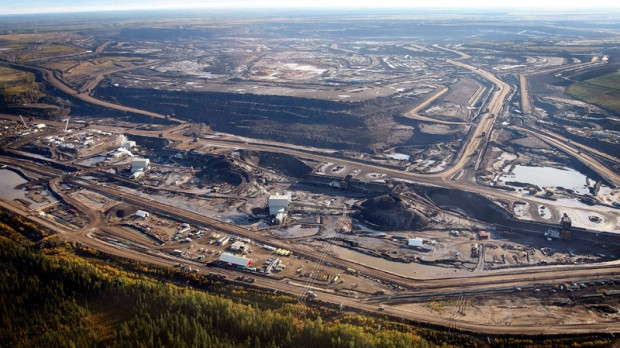 This aerial photo shows a tar sands mine facility near Fort McMurray, in Alberta, Canada. Alberta has the world's third-largest oil reserves after Saudi Arabia and Venezuela - more than 170 billion barrels. (Jeff McIntosh / THE CANADIAN PRESS)