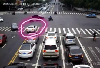 18岁留学生开宝马逆行闯红灯 拖行交警30多米