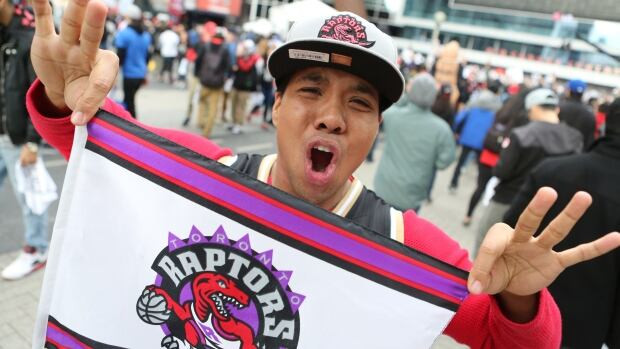Jason Caluducan has the hat, the jersey and the flag ready ahead of Thursday night's Game 2. The Toronto Raptors are tied 1-1 in a best-of-seven series with the Miami Heat. The winner moves on to the Eastern Conference Finals. 