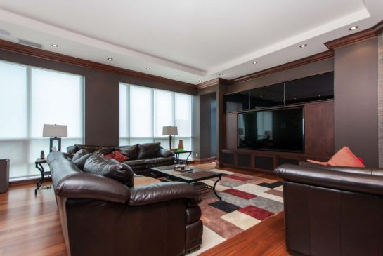 The custom family room features a surround-sound entertainment system and a media wall.