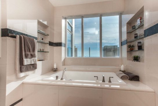 The ensuite bathroom has a soaker tub and lots of natural light.