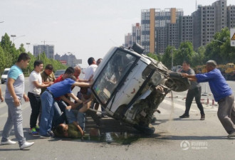 面包车撞护栏侧翻 路人合力推车营救被压司机