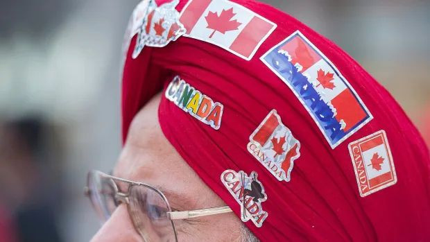 A man wears patriotic stickers on his turban at the Canada Day parade in Montreal.