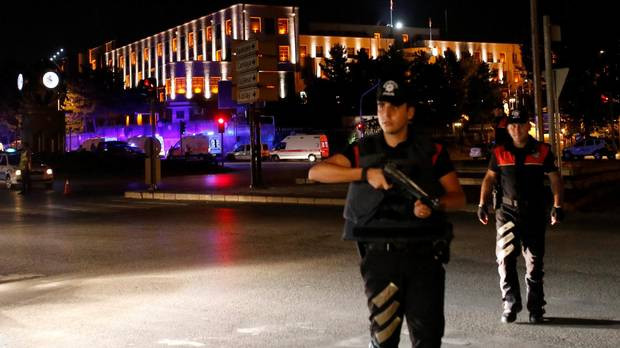 Police officers stand guard near the Turkish military headquarters in Ankara, Turkey, on July 15, 2016. (TUMAY BERKIN/REUTERS)