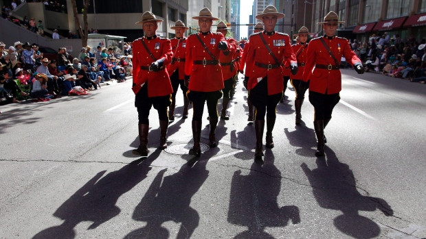 Members of the RCMP march during the Calgary Stampede parade in July 2013. Mounties are turning down overtime for participating in appearances such as these as a protest over working conditions.
