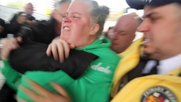 Ute Schmid-Jones, who ran for the Green Party in the 2015 federal election, was grabbed by security after she tried to throw pumpkin seeds at Prime Minister Justin Trudeau in Hamilton on Friday.