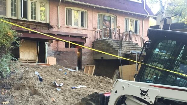 A worker in his 40s is dead after a cinder block wall collapsed, trapping him briefly, in Toronto's Beach neighbourhood.