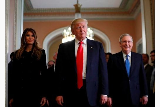 President-elect Donald Trump and his wife Melania walk with Senate Majority Leader Mitch McConnell of Ky. after a meeting on Capitol Hill on Nov. 10, 2016.
