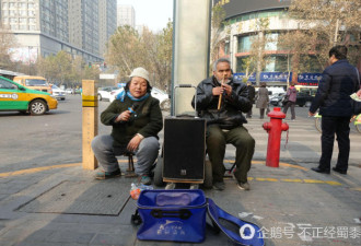 夫妻俩共用“一只眼” 鼻孔吹箫卖艺为生