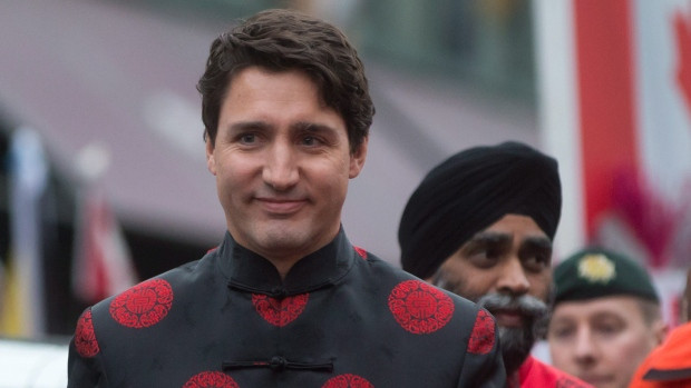 Prime Minister Justin Trudeau and Defence Minister Harjit Sajjan, back right, attend the Lunar New Year parade in Vancouver, B.C., on Sunday, Jan. 29, 2017. 