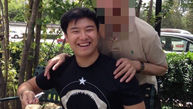 Peng Sun smiles in this family photo taken on his birthday during a barbecue.