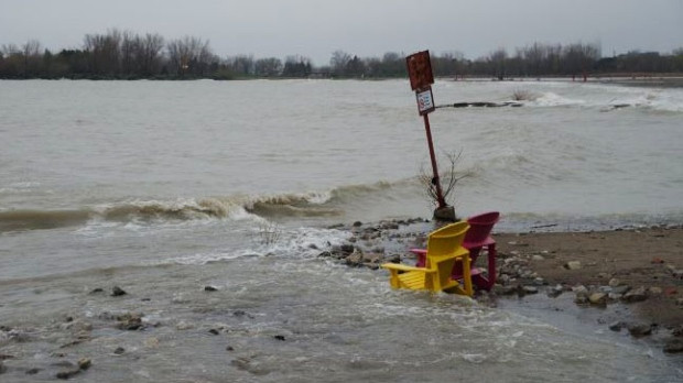 Broad ponds have engulfed Woodbine Beach, drowning out nearby volleyball courts and stranding a set of Muskoka chairs. (Howard Chang/Twitter) 