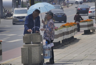 又是素质 山东人饮水点前拿巨桶装水