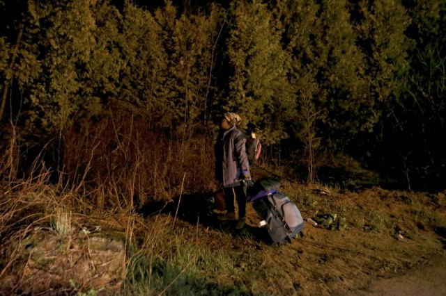 Cilotte hesitates before crossing the U.S.-Canada border into Canada from Roxham Road in Champlain, N.Y.