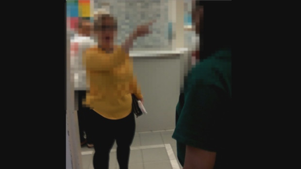 In a video, a woman (left) makes several demands for a