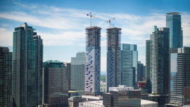 Men work at a construction site in downtown Toronto, on Thursday, June 30, 2016. (Eduardo Lima/The Canadian Press)