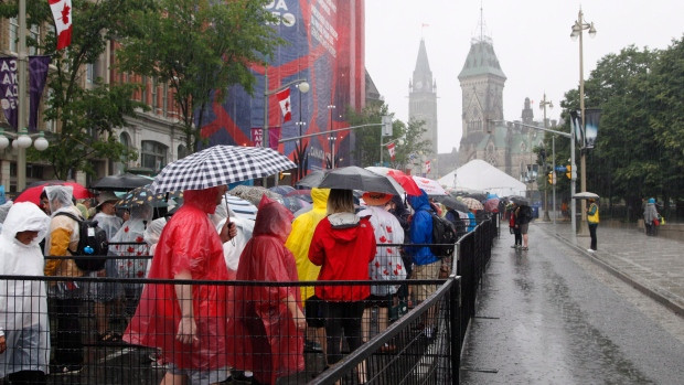 Members of the public wait in line to go through security screening before being allowed onto Parliament Hill on Canada Day in Ottawa on Saturday, July 1, 2017.