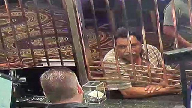 In this July 30, 2018 photo provided by the U.S. Attorney's Office in Detroit Juan Garcia-Jimenez right exchanges money at Caesars casino in Windsor, Ontario, Canada, before taking two men to an international railroad tunnel under the Detroit River. Garcia-Jimenez was sentenced to 16 months in prison Monday, April, 15, 2019, for helping immigrants try to illegally enter the U.S. The tunnel is used by cargo trains moving between Ontario, Canada, and the U.S. (U.S. Attorney's Office in Detroit via AP)