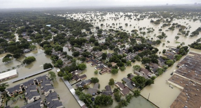 A neighborhood is flooded by rain from Hurrican Harvey in Houston. Two Ontario men are on their way to Houston to help a family member who has been forced from her home by flooding in the hurricane-battered city. 