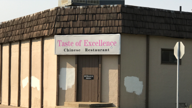 Two people volunteered to paint over racial slurs that had been scrawled on the outside of the Broadway Avenue business.